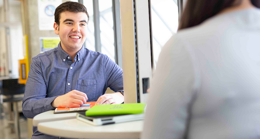 picture of a centennial college student volunteer chatting with a fellow volunteer